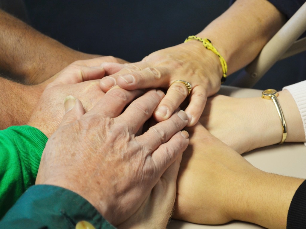 Group of people with placing hands together